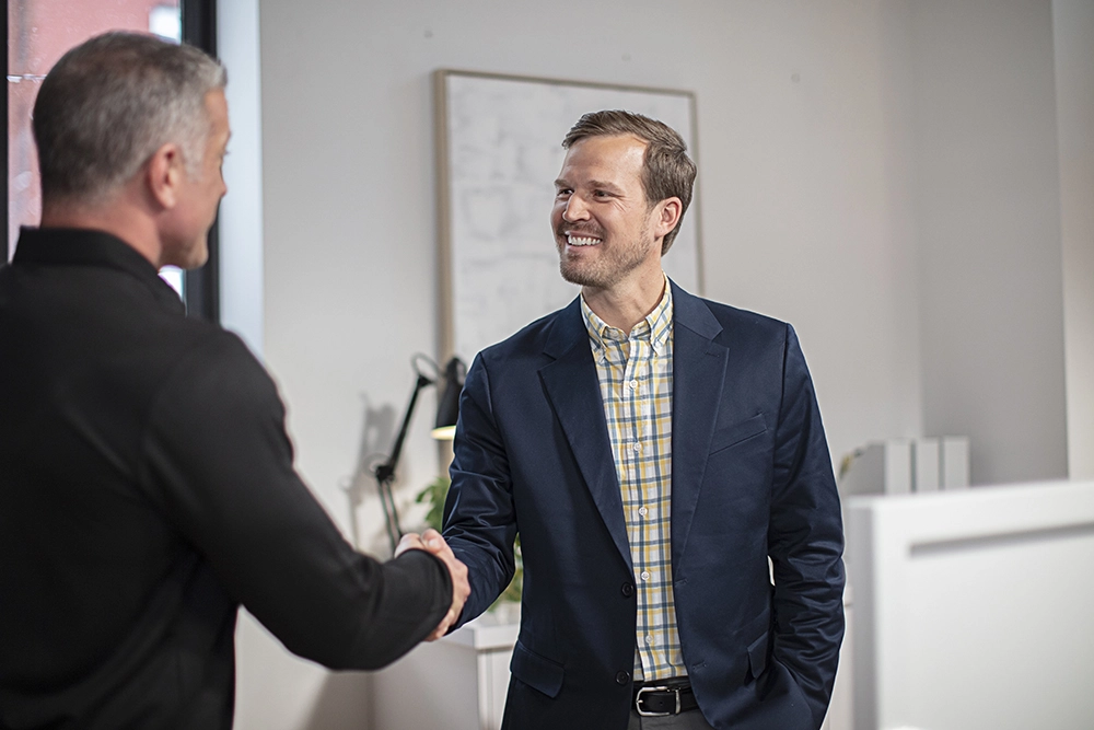 tech shaking hands with happy customer